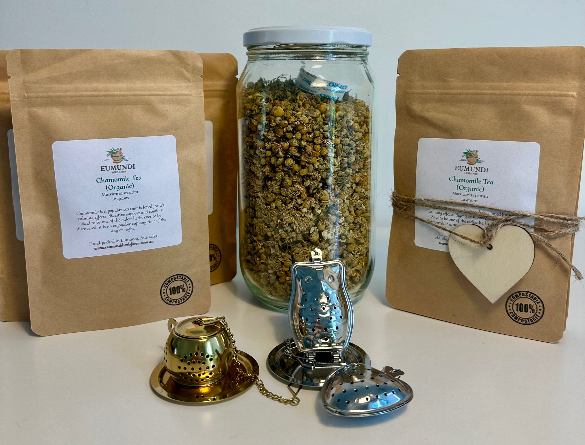 Tea packaging with jars, bags, and tea infusers on a white background